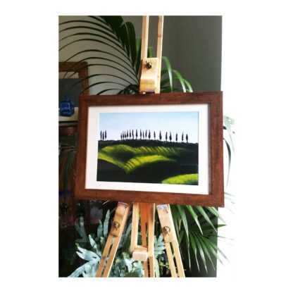 Framed art print of Tuscan landscape painting on an easel